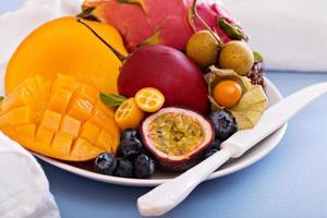 Exotic fruits on white plate photo