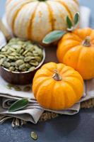 Pumpkins with seeds and sage leaves photo