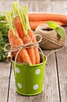 Fresh carrot with green leaves photo