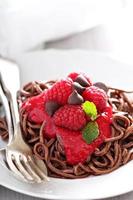 Cooked chocolate pasta with raspberry sauce photo
