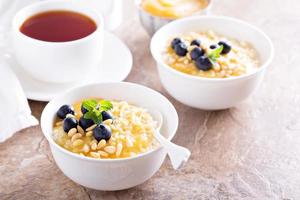 Cooked millet porridge with lemon curd and blueberry photo
