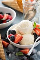 Vanilla ice cream scoops with berries photo