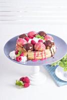 Saint-Honore cake with chocolate and raspberry photo