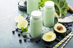 Green smoothies in small bottles to go photo