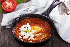 Shakshuka with tomatoes and eggs photo