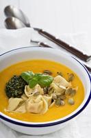 Pumpkin cream soup with cheese tortellini photo