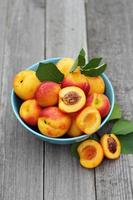 Fresh peaches in blue bowl photo