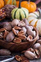 Pumpkins, nuts, indian corn and variety of squash photo
