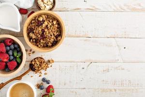 Breakfast table with granola and fresh berries photo