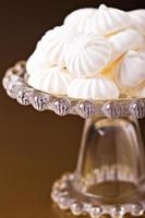 Meringue kisses cookies on a cake stand photo