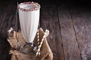 White chocolate milkshake in tall glass photo