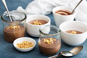 Chocolate yogurt dessert with salted peanuts photo