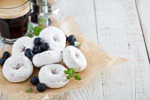 Powdered sugar donuts on parchment photo