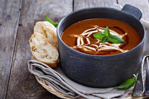Spicy tomato cream soup with bread photo