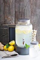 Ginger homemade lemonade in a beverage dispenser photo