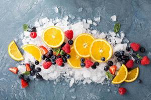 Oranges and berries on ice photo