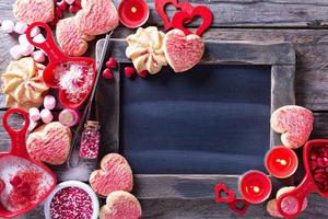 Valentines day cookies around a chalkboard photo