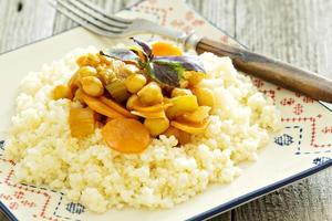 Cooked couscous served with stewed vegetables and chickpeas photo