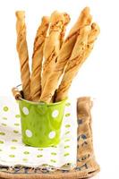 Bread sticks with cheese on white photo