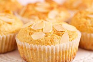 Almond muffins freshly baked, close up on board photo