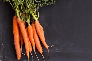 Fresh carrot with green leaves photo