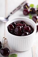 Homemade cherry sauce in white ramekin photo