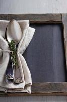 Tablespoons with a napkin and thyme photo