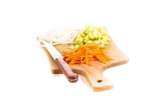 Carrot, onion and celery on a cutting board photo