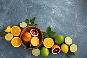 Citrus fruits background with oranges, limes and lemons photo