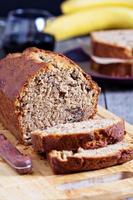 Banana bread with pecan nuts cut on the table photo