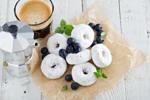 Powdered sugar donuts on parchment photo