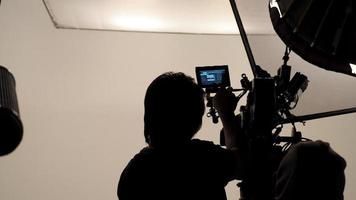 Silhouette of photographer checking for movie camera. photo