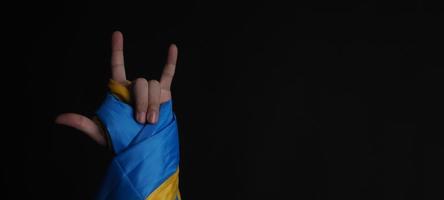 Russian flag and Ukraine flag in hands showing symbol of struggle war photo