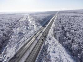 High-voltage power lines crossing the highway. photo