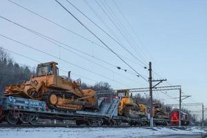 Railway transportation of caterpillar mining bulldozers. photo