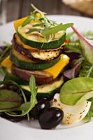 Grilled vegetables stacked on plate photo