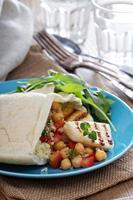 Pita bread with couscous and chickpeas photo