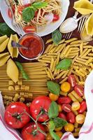 Pasta different types with tomatoes and basil photo