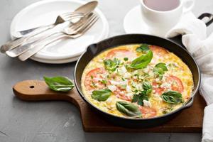 Frittata with tomatoes and feta cheese photo