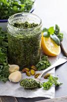 Kale pesto with pistachios, garlic and olive oil photo
