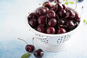 Fresh ripe sweet cherries in a colander photo