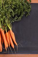 Fresh carrot with green leaves photo