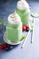 Green smoothie with whipped topping photo