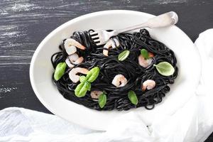 Squid ink homemade pasta with shrimp photo