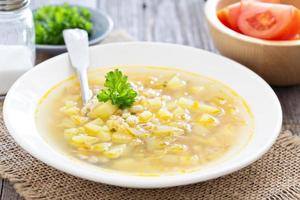 Soup with salted cucumbers and pearl barley photo