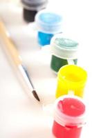 Different paint in small plastic jars photo