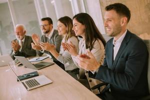 Satisfied proud business team clapping hands photo