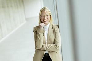 Business woman standing in the office corridor photo