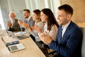 Satisfied proud business team clapping hands photo