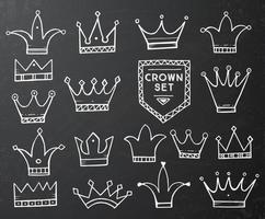 Set of Hand Drawn Cartoon Crowns on Black Chalkboard. vector